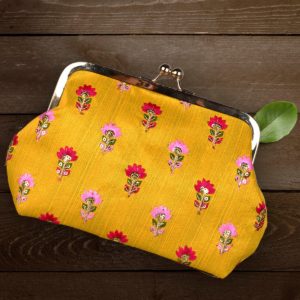 Pink flower embroidery on yellow fabric clutch